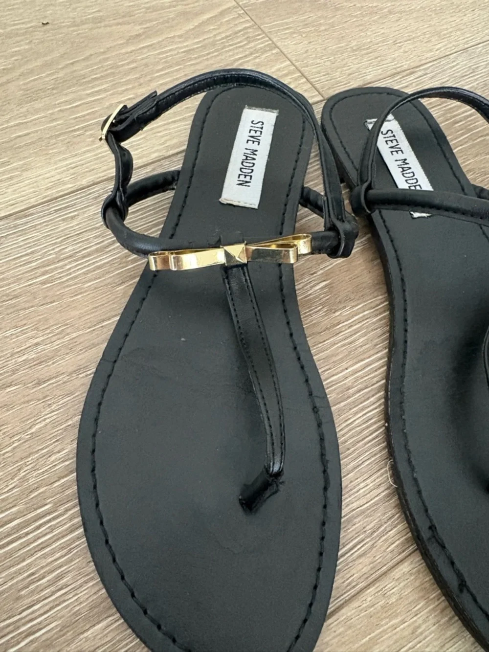 Steve Madden Black T-Strap Sandals with Gold Bow Accent